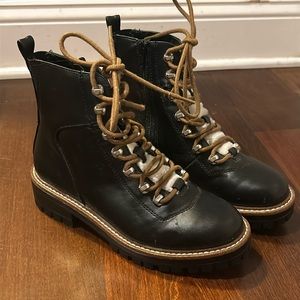 Black boots with white fur tongue